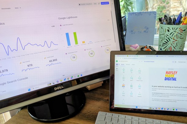 Computer screens and keyboard on a desk showing software tools on screen