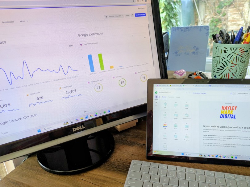 Computer screens and keyboard on a desk showing software tools on screen